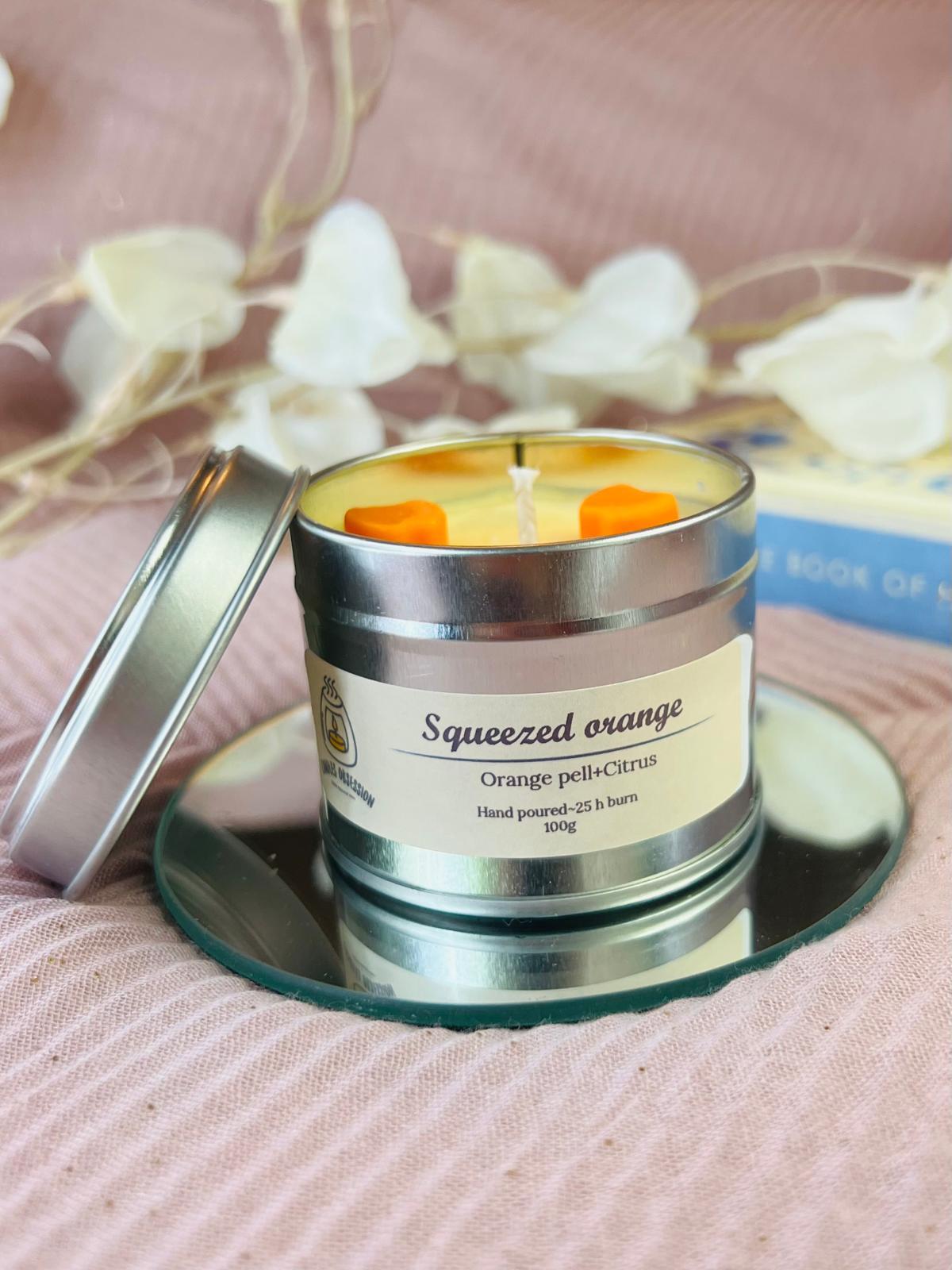 Squeezed orange tin candle