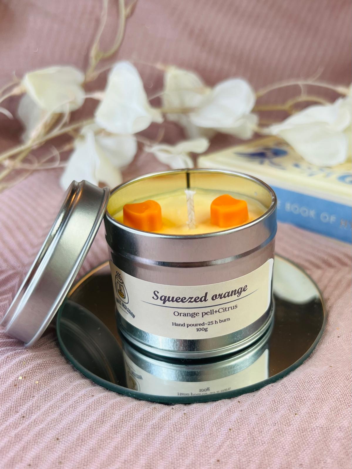 Squeezed orange tin candle