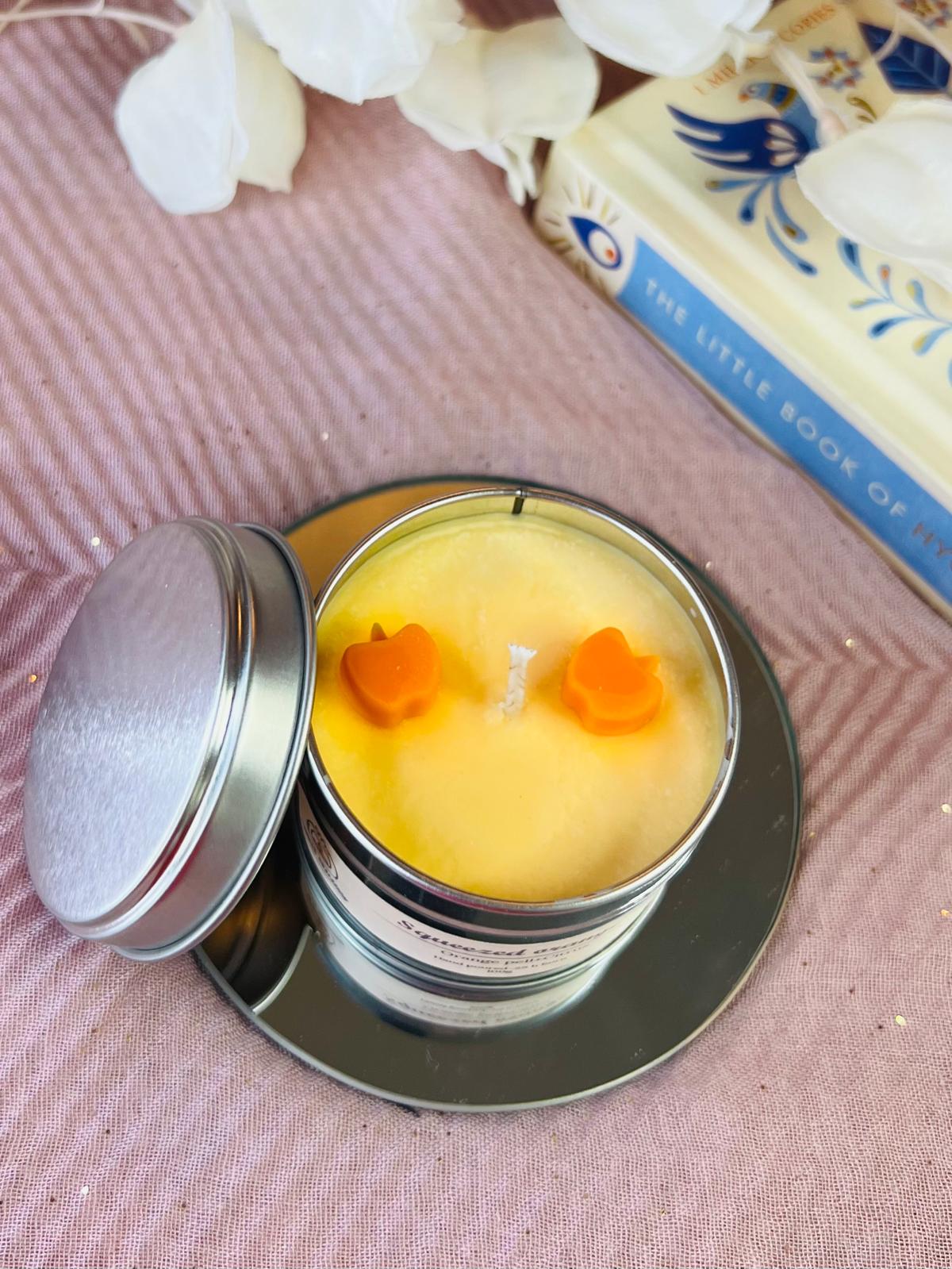 Squeezed orange tin candle