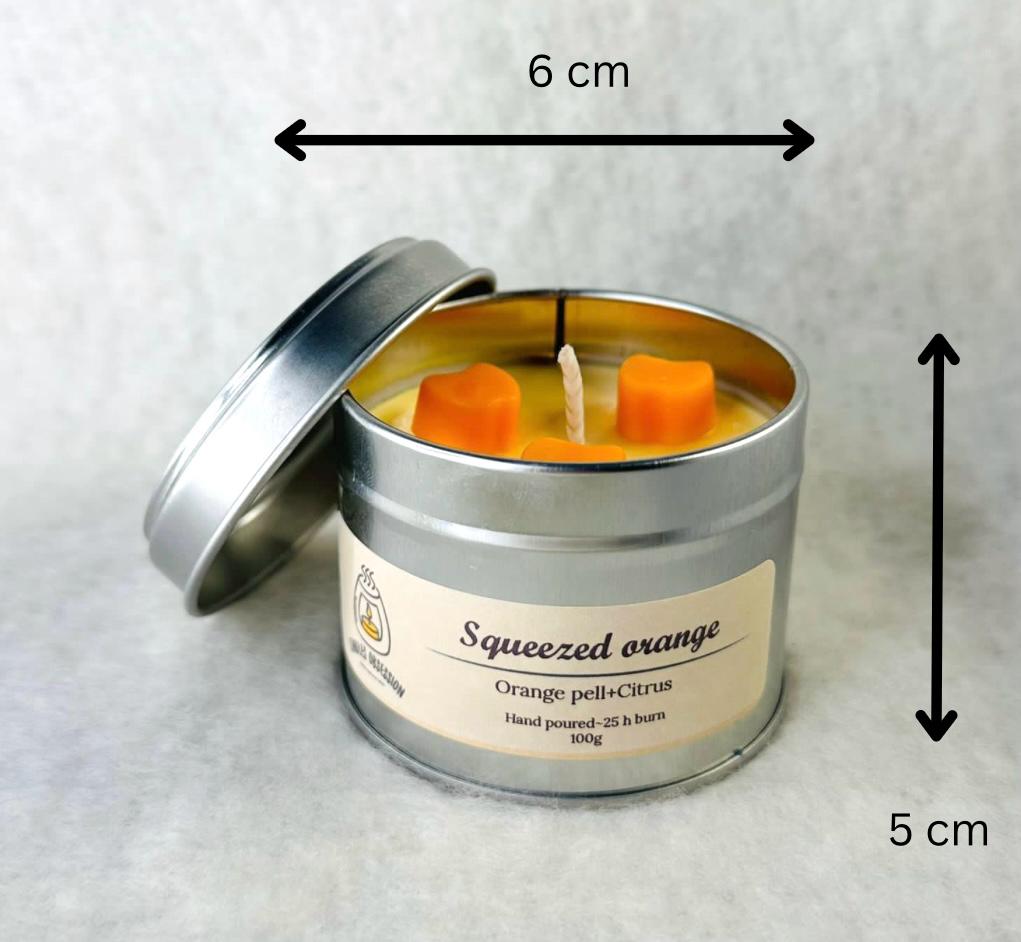 Squeezed orange tin candle